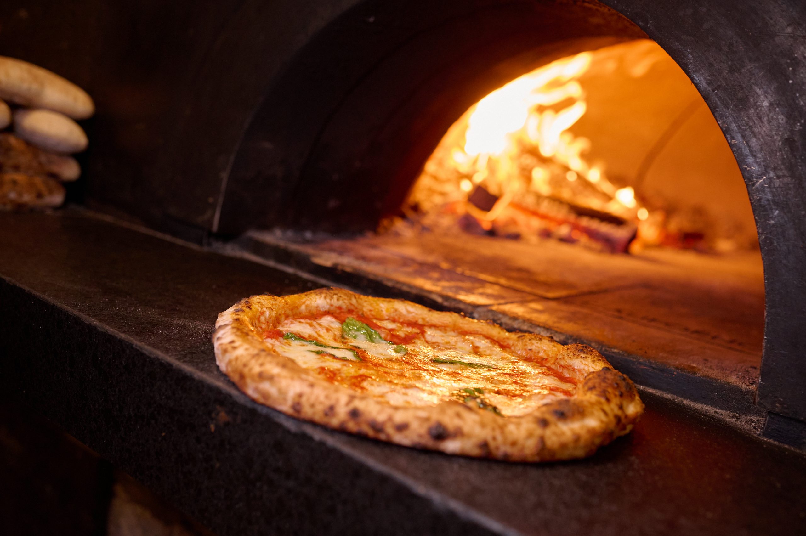 Ironside Pizza's signature dish, a pizza, cooked on a stone oven at one of the best Italian restaurants in Miami.